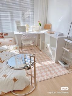 a bedroom with a bed, desk and computer on it's side table in front of a window