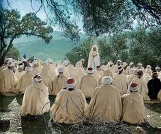 a large group of people sitting on the ground