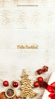 a white wooden background with christmas decorations and presents