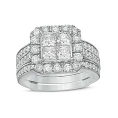 a white gold ring set with two princess cut diamonds on the sides and an intricate band