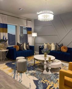 a living room filled with blue couches and yellow chairs on top of a rug