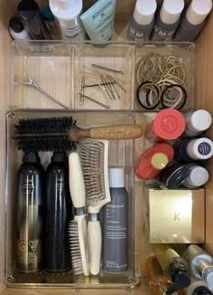 an organized drawer containing various items such as brushes, hairdryers and other personal care products