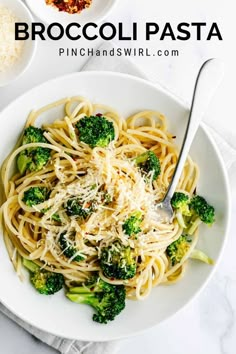 broccoli pasta with parmesan cheese in a white bowl on a marble table