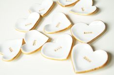 heart shaped cookies with the word love written on them are arranged in a row and placed next to each other