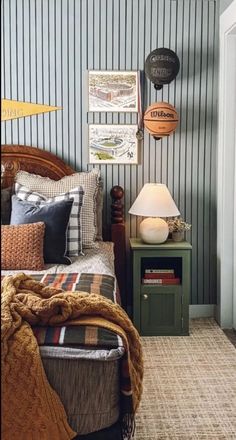 a bedroom with striped walls and a bed in the corner next to a night stand