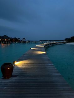 a wooden dock with lights on it at night