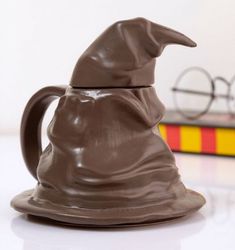 a close up of a chocolate mug with a harry potter hat on it