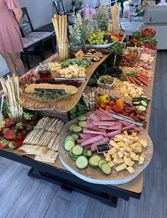 a table filled with lots of different types of food on it's trays