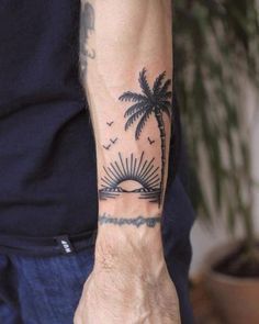 a man with a palm tree tattoo on his arm