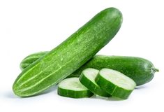 cucumbers with slices cut in half on white background