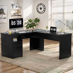 an office desk with a clock on the wall above it and a plant in front of it