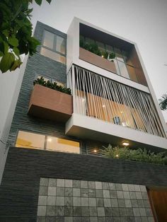 an apartment building with plants growing on the balconies