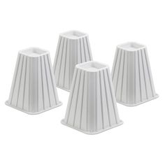 four white candlesticks sitting next to each other