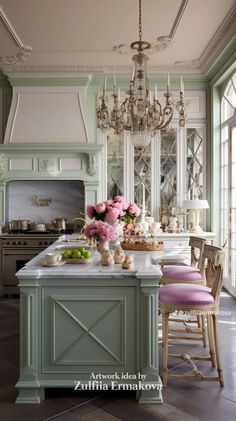 a kitchen with an island, chandelier and pink chairs in the middle of it