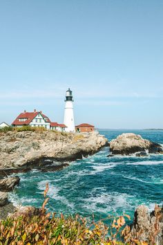 a light house sitting on top of a cliff next to the ocean