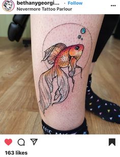 a woman's leg with a fish tattoo on it and an image of a goldfish