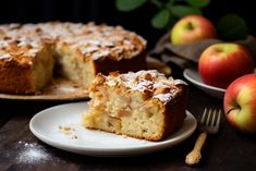 a piece of cake sitting on top of a white plate next to an apple pie