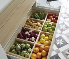 an open drawer filled with assorted fruits and vegetables