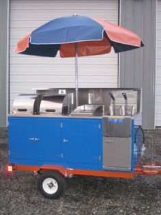 a blue and red cart with an umbrella over it