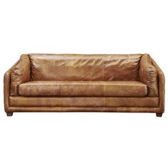 a brown leather couch sitting on top of a white floor