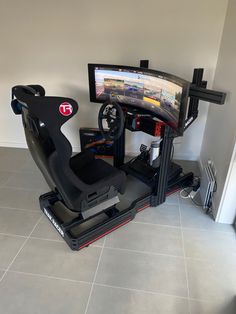 a video game driving simulator sitting in front of a flat screen tv