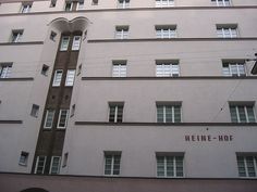 a tall white building with windows and a sign on the side of it that says heinze - hof