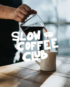 a person pours coffee into a cup with the words slow coffee club on it