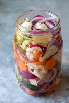 a glass jar filled with lots of veggies