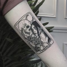 a woman's arm with a tattoo on it that says love and two skulls