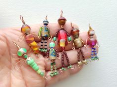 there are many different colored beads in the hand