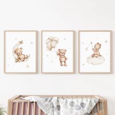 three framed pictures hang on the wall above a crib in a baby's room