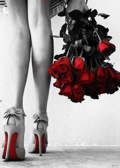 a woman in high heels holding a bouquet of roses