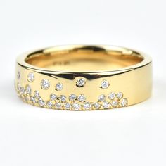 a gold wedding band with diamonds on it