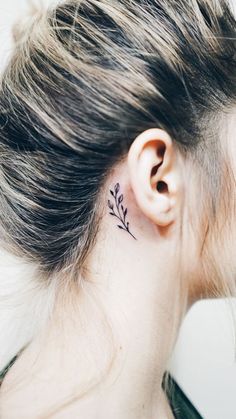 a woman with a small tattoo behind her ear