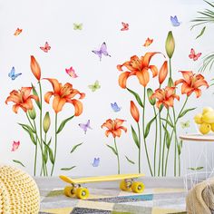 a room with flowers and butterflies painted on the wall next to a yellow skateboard