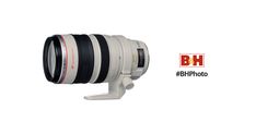 a camera lens sitting on top of a white stand with the words bh behind it