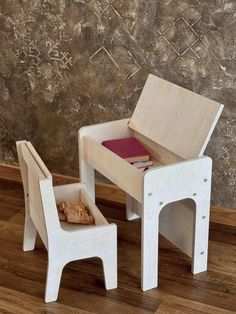 a wooden chair and table with a book on it