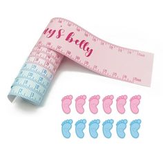 baby feet and measuring tape with stickers on white background for scrapbooking or crafts