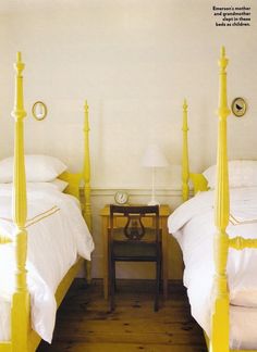 two beds with green posts and white sheets