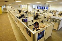 an office filled with lots of cubicles and computers