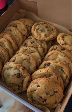 a box filled with chocolate chip cookies on top of a table