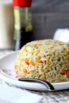 a plate with rice and carrots on it