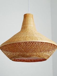 a woven light fixture hanging from a ceiling