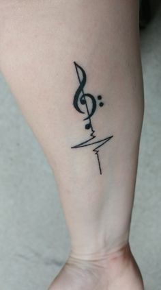 a woman's foot with a musical note tattoo on her left side calf area