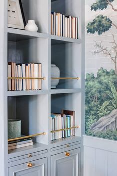 a book shelf with books on it in front of a wallpapered background and the words instagramn