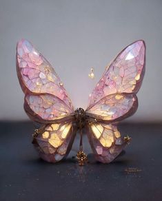 a pink butterfly sitting on top of a table next to a white wall with the words art community and mirada morrada