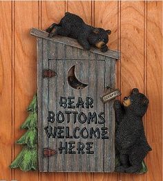 two bears are sitting in a birdhouse with the words bear bottoms welcome here on it