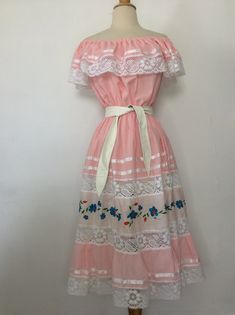 "Vintage Dress 1970's Vintage Oaxacan Mexican Wedding Dress Pink Cotton or Cotton Blend. No tags Elastic Top, so can be worn Off or On Shoulder 6\" Ruffle with White Lace and Ribbon Trim Elastic Waist The Skirt has 2 Sheer Lace Inserts with an Embroidered Panel in between I have it shown with and without a belt. Belt Not Included. No size tag, so Please go by measurements taken laid flat seam to seam 20-23\" armpit to armpit 10-21\" waist 26\" hips 35\" long from armpit Excellent Vintage Conditi 1970s Mexican Fashion, Mexican Pink Dress, Mexican Dress Aesthetic, 1960s Mexican Fashion, Pink Mexican Outfit, Traditional Mexican Dress For Women, 80s Mexican Fashion, Guatemalan Dresses, Vintage Mexican Fashion