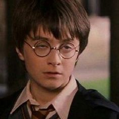 the young harry potter is wearing glasses