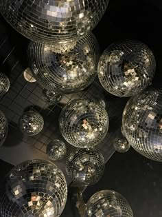 many shiny disco balls hanging from the ceiling